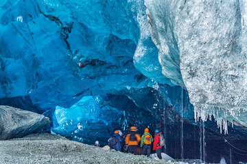 Tourists are mesmerized by the beauty of an ice cave in Iceland.