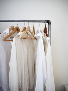White shirts hanging on clothes rack