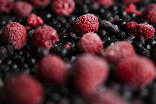 Close-up of pile of raspberries and blackcurrants