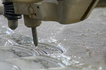 Close-up scene of multi-axis abrasive waterjet cutting machine cutting the aluminum plate.