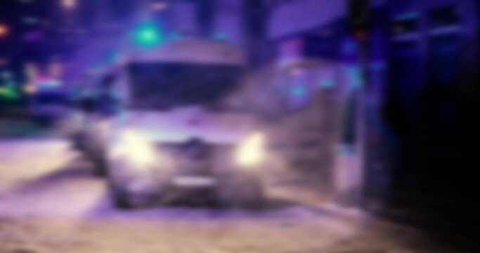 Defocused blur view of police special mobile police force vans with blue beacons on a winter night