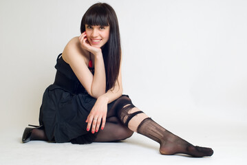 Young attractive woman in torn stockings