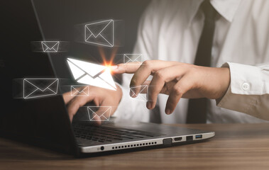New email notification concept. Businessman using computer laptop with virtual white newsletter for electronic mail or E-mail with notification alert concept. internet technology.