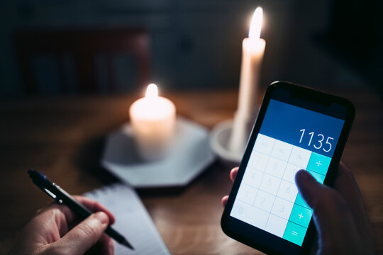 Person calculating energy prize on phone