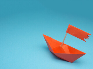 New ideas or transformation concept with a paper boat on a blue backgrond