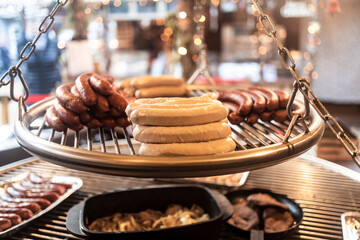 Barbecue grill with sausages on christmas market - obrazy, fototapety, plakaty