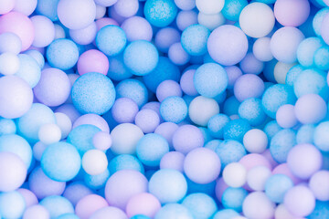 Colorful balls background in pink and blue colors. Background with colorful balls in different sizes. Sphere of balls on pastel color.