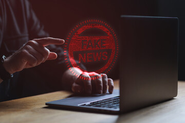 Fake news concept. Man points at Fake news text