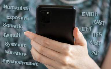 Person hand with smartphone and different psychotherapy kind names. Therapy choice online concept.