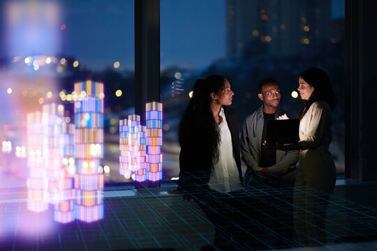 Three young business people working together in office