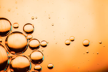 Microbubbles in mixed water and oil background, colorful abstract yellow - green led lights, super-macro abstraction