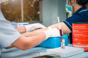 Close up Hand of nurse, doctor or Medical technologist in gloves taking blood sample from a patient in the hospital.