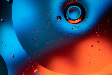 Microbubbles in mixed water and oil background, colorful abstract yellow - green led lights, super-macro abstraction