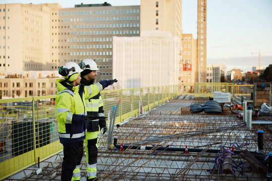 Two engineers working at construction site