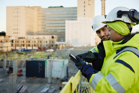 Two engineers working at construction site