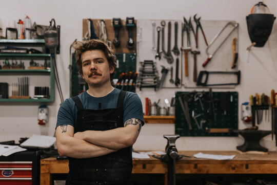 Portrait of blacksmith in workshop - Powered by Adobe