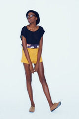 Fototapeta premium Her style is unique and all her own. An african american hipster posing in the studio.
