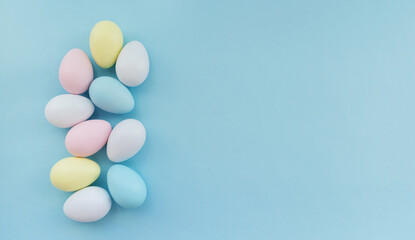 Fototapeta na wymiar Colourful Easter eggs on a pastel blue background.