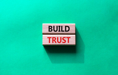 Build trust symbol. Wooden blocks with words Build trust. Beautiful green background. Business and Build trust concept. Copy space.
