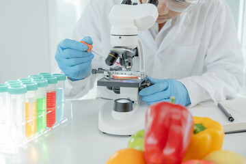 Scientist check chemical fruit residues in laboratory. Control experts inspect the concentration of...