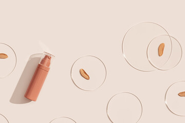 Cosmetic product, bottle of makeup foundation cream, cosmetics swatches nude color on glass disks...