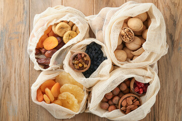 Tu Bishvat celebration concept. Mix of dry fruits and nuts almonds, hazelnuts, walnuts, apricots, prunes, cherries, raisins, dates, apples, figs over wooden table. Jewish holiday, new year of trees.