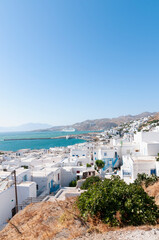 Vertical panorama of the picturesque Mykonos island houses and coastline against the blue sky