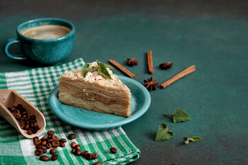 Layered Cake with cream Napoleon with mint on green background. Copy space