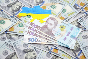 American dollars and Ukrainian hryvnia. The concept of the American aid to Ukraine in the war.