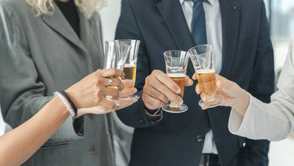 Business people drinking champagne to celebrate success of investment agreement after meeting, teamwork and partnership concept.