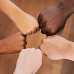 Circle of diverse hands, fists in circle, different skin colours unity teamwork