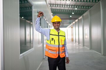 Indian worker standing confident in factory background