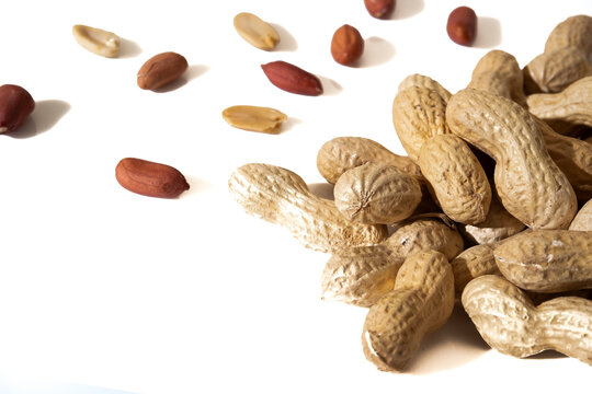 Peanuts in shell isolated on white background. Heap of peanuts close up	