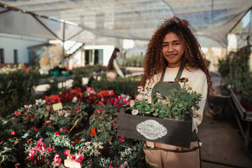 Woman gardener holding a box of flowers