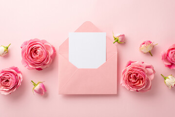 Fototapeta na wymiar Saint Valentine's Day concept. Top view photo of open pink envelope with paper sheet and peony roses on isolated pastel pink background with copyspace