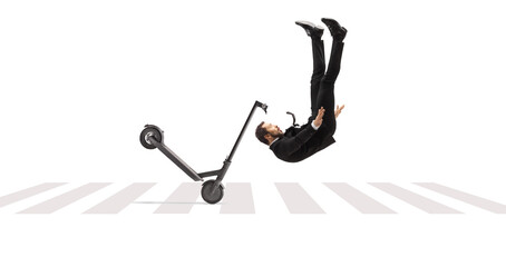 Businessman tumbling with an electric scooter on a pedestrian crossing