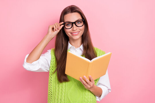 Photo of young woman positive stylish wearing classic vest librarian outfit reading book touch specs smart person isolated on pink color background