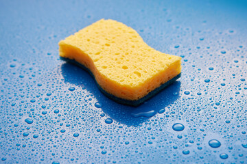 Wash sponge on table with water drops