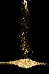 Sprinkle gold dust on a black background with copy space - 581138695
