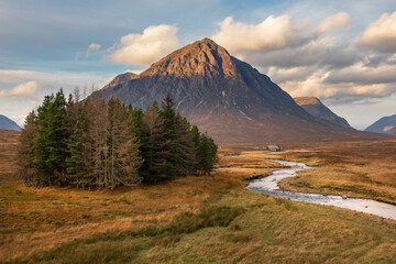 Winding river leading to classic viewpoint of Glencoe mountain Buachaille Etive Mor with golden morning light hitting peak. Scottish Highlands, UK. © _Danoz