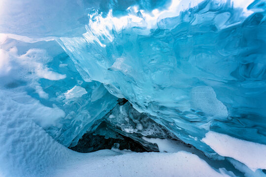 Natural ice cave in frozen lake on winter