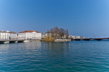 Obraz premium Rhone River with Mont Blanc bridge in the background at Swiss City of Geneva on a sunny winter day. Photo taken March 5th, 2023, Geneva, Switzerland.