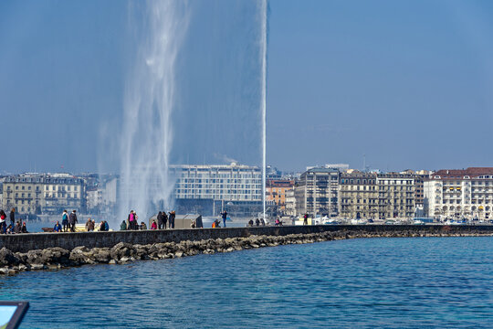 Beautiful and famous jet d'eau water fountain at Lake Geneva at Swiss City of Geneva on a sunny winter day. Photo taken March 5th, 2023, Geneva, Switzerland.