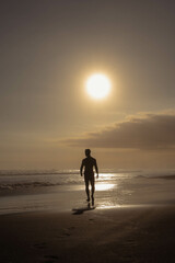 Naklejka premium Walking on the Beach at Sunset in Bali, Indonesia