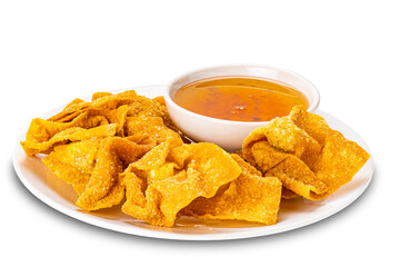Pile of crispy delicious homemade deep fried wontons in white ceramic plate and sweet dipping sauce in white ceramic cup isolated on white background with clipping path.