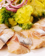 Salted fish with boiled potato and pickled onions