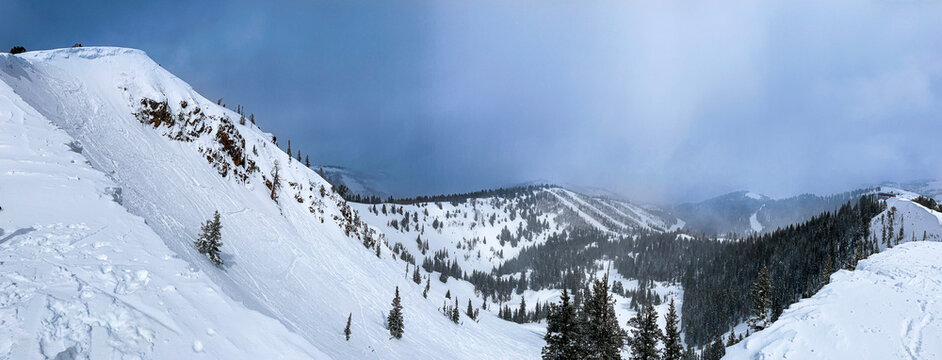 Panorama of snowy mountains of Park City ski resort as seen from the top of McConkey's hike.