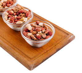 Assorted nuts in a glass bowls on wooden