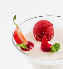 Italian dessert panna cotta with red fresh strawberries