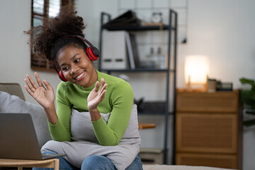 Fototapeta premium Happy african american woman having video call with her family.